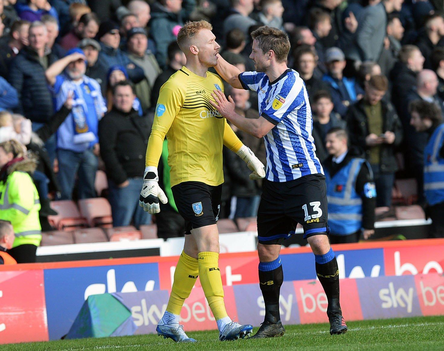 Owls goalkeeper Cameron Dawson, left, is consoled by Julian Borner after his Barnsley mistake Pic Steve Ellis