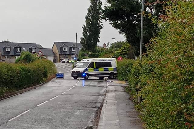 A police van remains on the scene in Duckmanton.