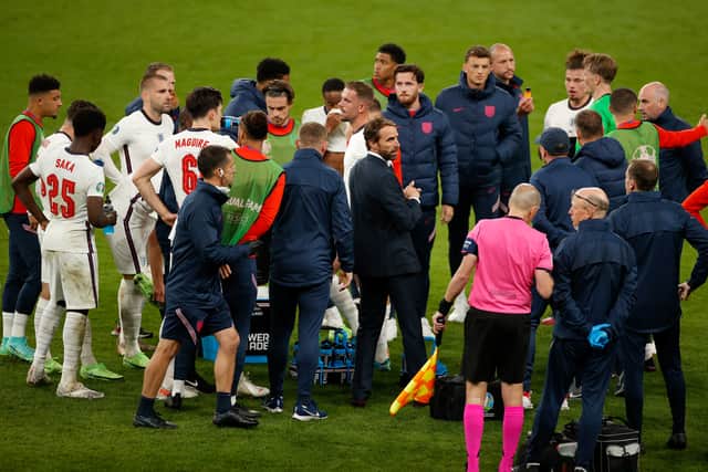 Gareth Southgate looks on as he speaks with his players before extra-time