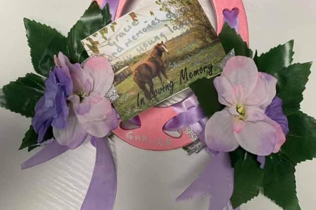 A pink horseshoe dedicated to Gracie from a loved one.