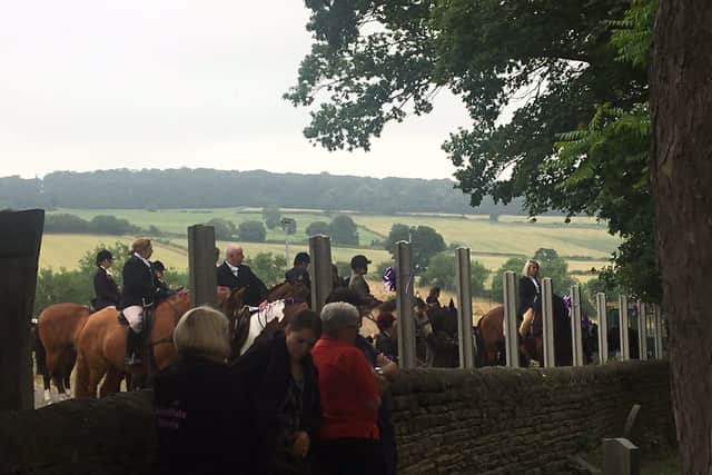 Horse riders wait outside the church.