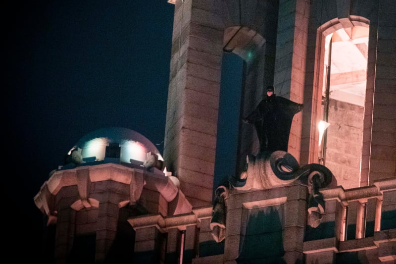 During shooting in October 2020, Batman stood atop the Liver Building as it was used as the Gotham City Police Department with helicopters circling above.
The Caped Crusader could also be seen at Anfield Cemetery, while St George’s Hall was used as Gotham City Hall.