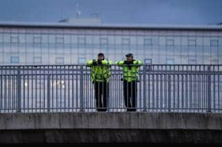 Police officers watch from a footbridge above the Kingsway in the centre of Glasgow ahead of the start of the Cop26 summit in the city.