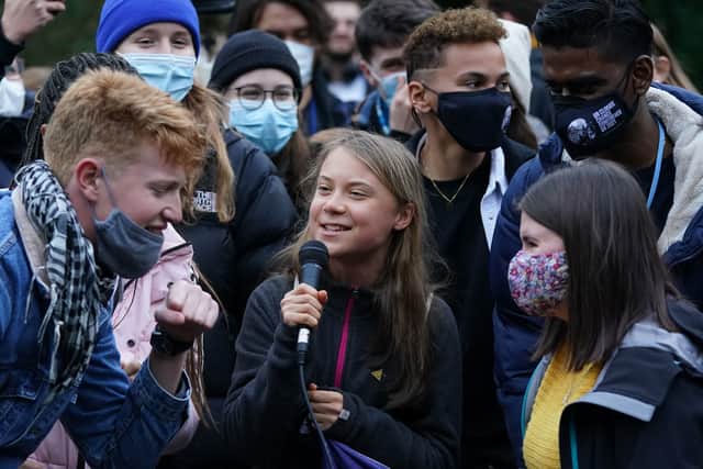 Greta Thunberg alongside fellow climate activists during a demonstration at Festival Park, Glasgow, on the first day of COP26. 