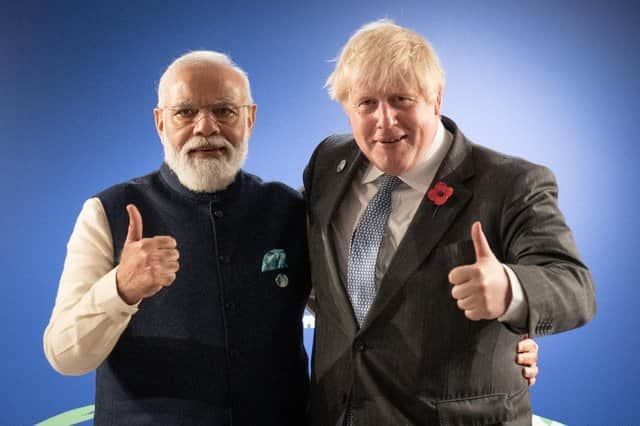 Prime Minister Boris Johnson (right) greets India’s Prime Minister Narendra Modi ahead of pledges to end deforestation and have India set a net-zero emissions target.