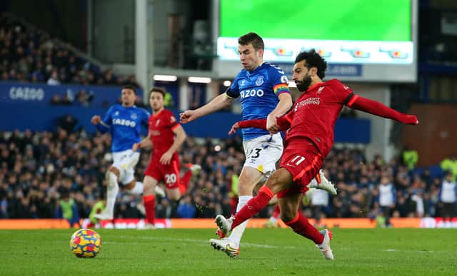 <p>Mohamed Salah of Liverpool scores their side's third goal whilst under pressure from Seamus Coleman of Everton during the Premier League match between Everton and Liverpool at Goodison Park on December 01, 2021 in Liverpool, England. (Photo by Alex Livesey/Getty Images)</p>
