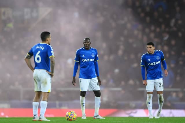 Abdoulaye Doucoure of Everton looks dejected with teammates Allan and Ben Godfrey after the Liverpool fourth goal scored by Diogo Jota (Not pictured) during the Premier League match between Everton and Liverpool at Goodison Park on December 01, 2021 in Liverpool, England. (Photo by Laurence Griffiths/Getty Images)