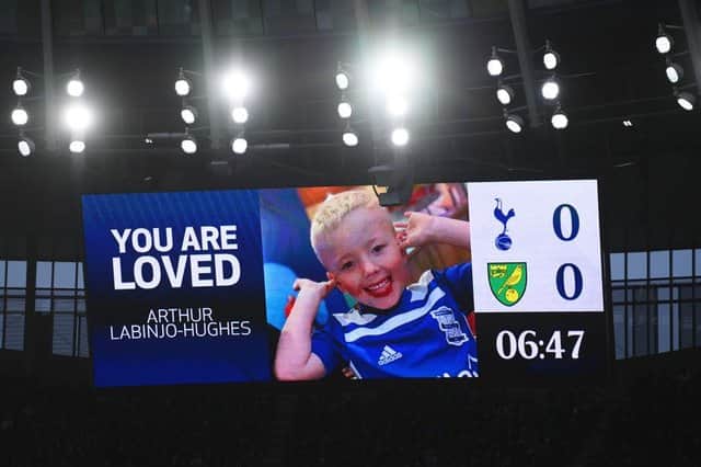 An LED board inside the stadium shows a photo of Arthur Labinjo-Hughes as fans hold a minutes applause in his memory during the Premier League match between Tottenham Hotspur and Norwich City at Tottenham Hotspur Stadium on December 05, 2021 in London, England. (Photo by Mike Hewitt/Getty Images)