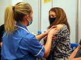 Caroline Nicolls receives an injection of the Moderna Covid-19 vaccine administered by nurse Amy Nash, at the Madejski Stadium, Reading