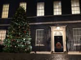 A Christmas tree stands illuminated outside number 10 Downing Street