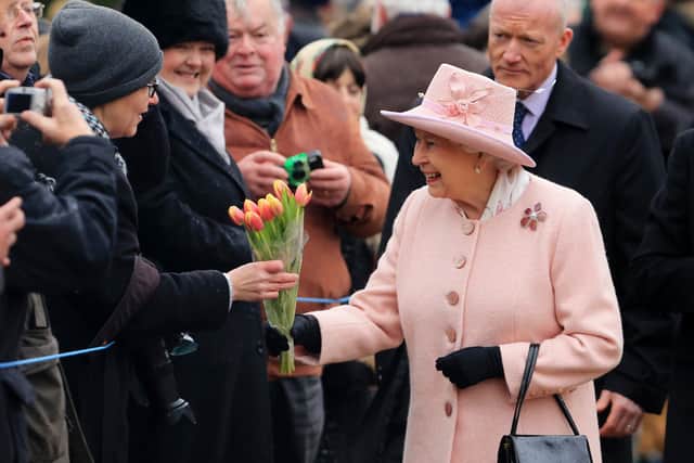 Queen Elizabeth II receiving flowers from well-wishers after attending the morning church service at West Newton Church near Sandringham in Norfolk (image: PA)