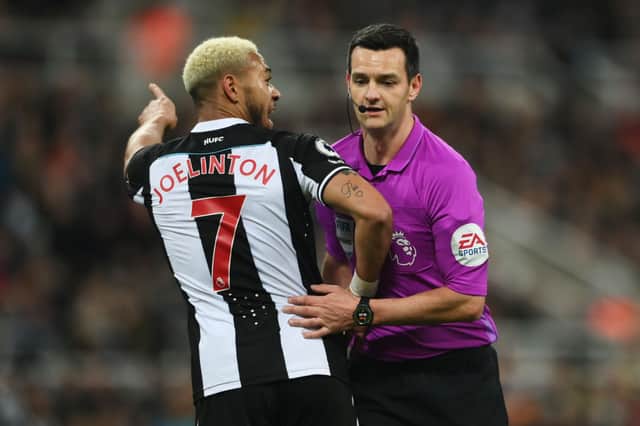 oelinton of Newcastle United speaks with Match Referee, Andy Madley during the Premier League match between Newcastle United and Norwich City at St. James Park. 
