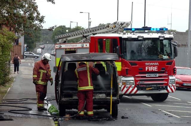 File picture shows firefighters dealing with a car fire. Fire engines were sent to two arson incidents in the early hours of Sunday
