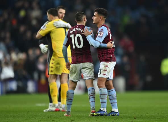 Philippe Coutinho of Aston Villa interacts with teammate Emiliano Buendia following the Premier League match between Aston Villa and Manchester United at Villa Park