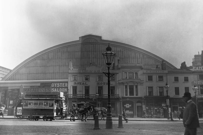 A horse drawn tram parked outside the main entrance of Lime Street Station.