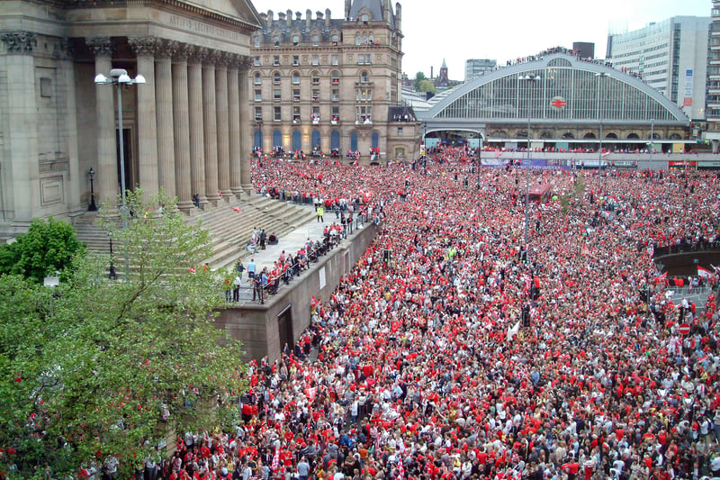 Liverpool fans crowd the streets around Lime Street waiting for the Liverpool team to parade the 2005 Champions League trophy.