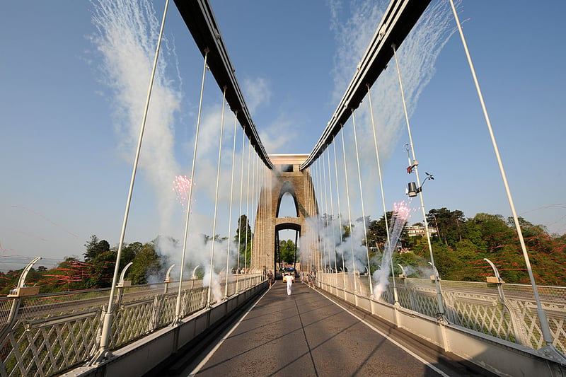 Olympic torchbearer Rebecca Pantaney runs across the bridge on May 23, 2012 with fireworks around her. (Getty Images)