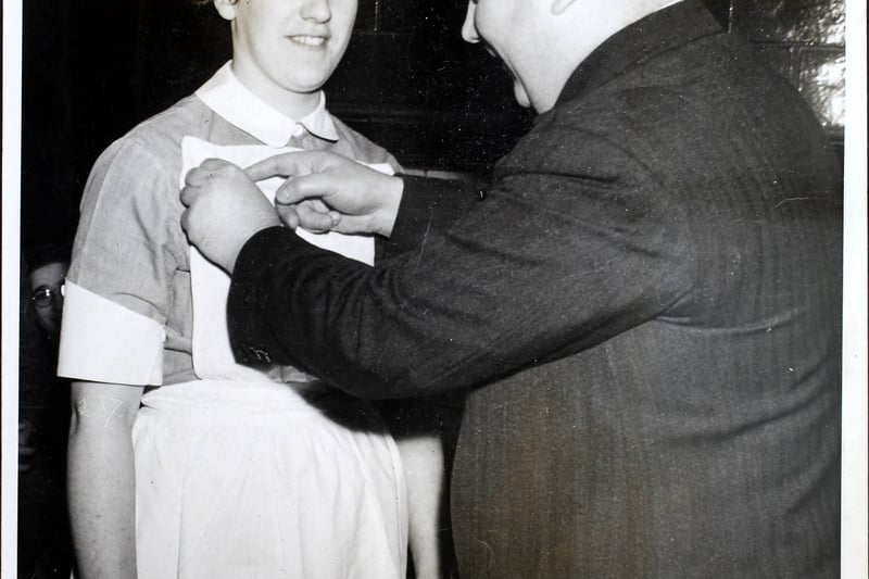 Nurse Nancy Roper is presented with the Gold Medal and Doctor Chadwick’s Prize by Councillor Onions, chairman of the Hospital House Committee, at the Booth Hall Hospital for Sick Children, Manchester 