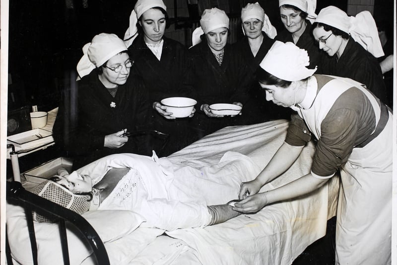 Nurses of the Civil Nursing Reserve learn simple wound dressing during training at the Salford Royal Hospital, 1939. 