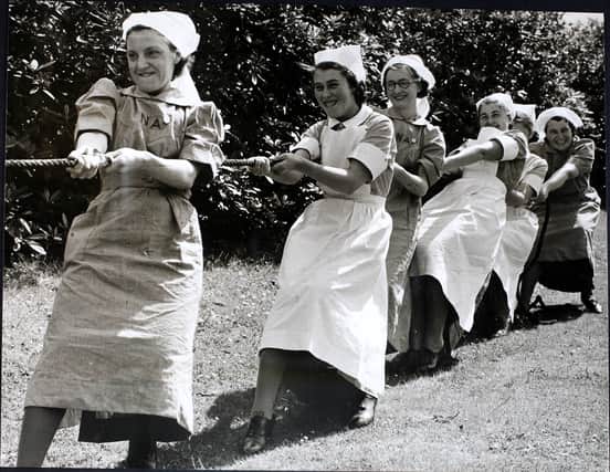 Regular and auxiliary nurses of the Booth Hall Hospital in Manchester relax with tug of war in 1940 