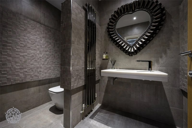 A very modern and stylish bathroom area.