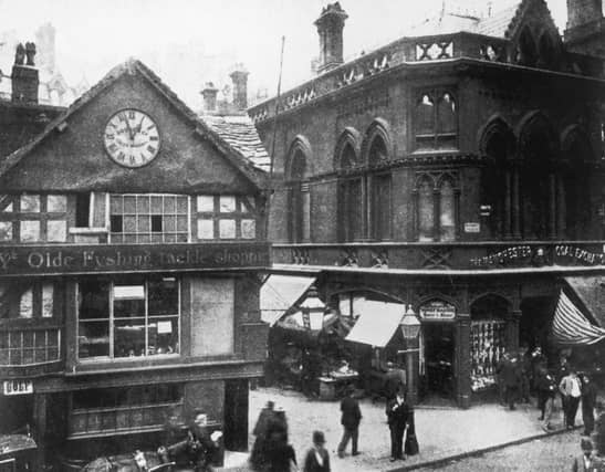 Ye Olde Fyshing Tackle Shoppe and the Coal Exchange in Manchester Market Place, circa 1900.
