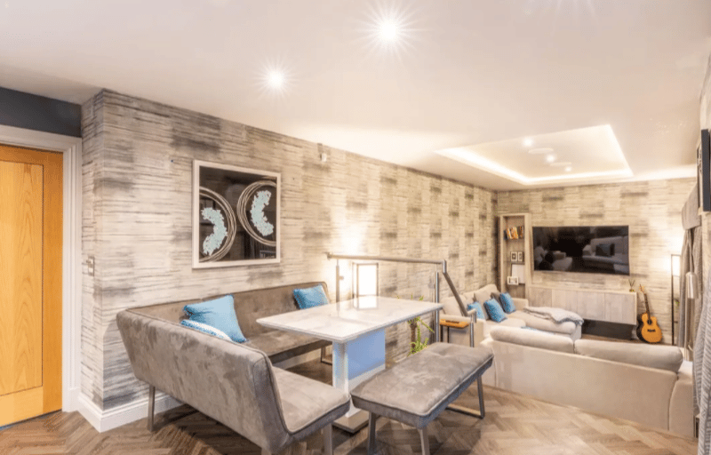 Off the kitchen there is a dining space with a cosy sunken living room space.