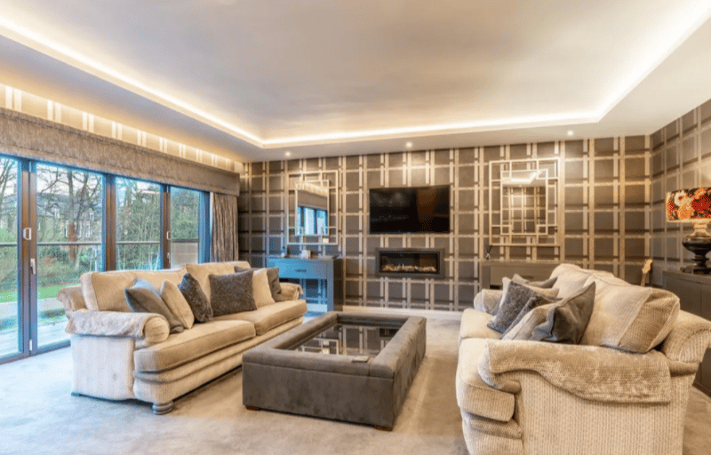 This huge living room opens up onto the garden, and has a cosy built in fireplace.