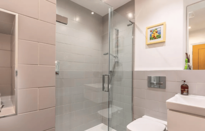 Spacious shower with sunken wall shelf for storage. 