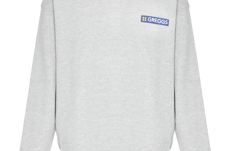 “The Greggs crewneck sweatshirt is business in front, pastry at the back. Featuring the classic Greggs logo on the chest, with a trio of punchy logos on the back.”