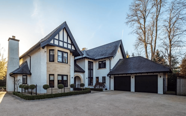 The striking exterior of the luxury home with gated driveway and double garage
