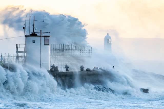 Waves crash against the harbour wall in Porthcawl, Wales. All of Wales rail services have been suspended and most schools will close. (Photo by Matthew Horwood/Getty Images)