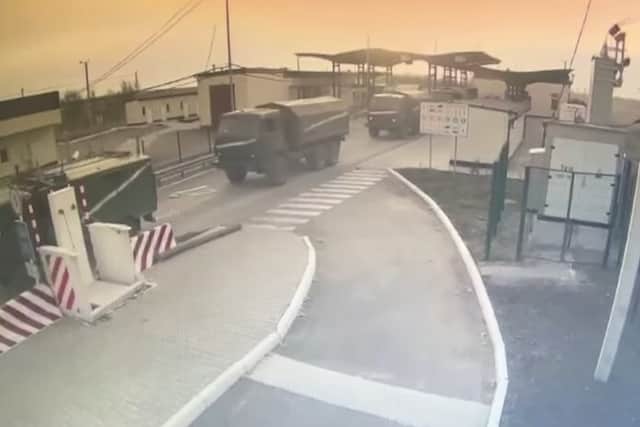 Handout screengrab taken from CCTV issued by State Border Guard Service of Ukraine of Russian military vehicles moving across the border from Crimea into Ukraine
