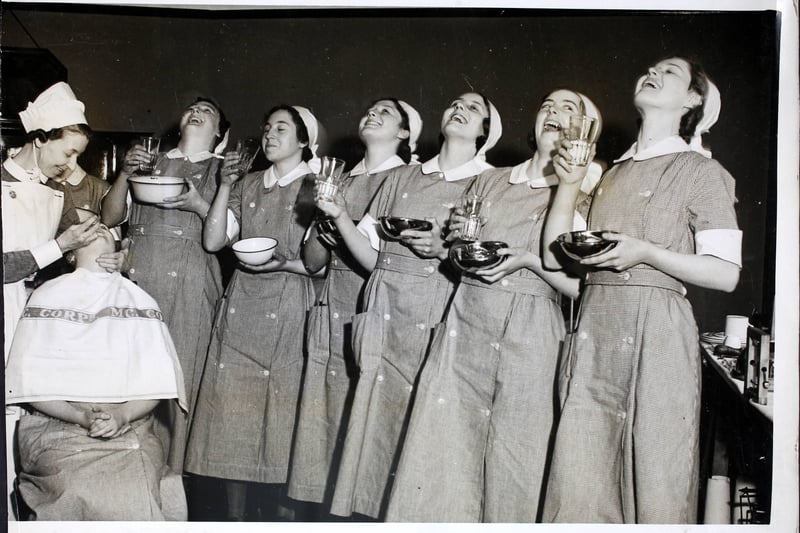 Nurses gargling to prevent ‘flu at the Booth Hall Hospital, Manchester, while another gets a throat spray, England.A wave of influenza has followed the sudden changes in the weather. 