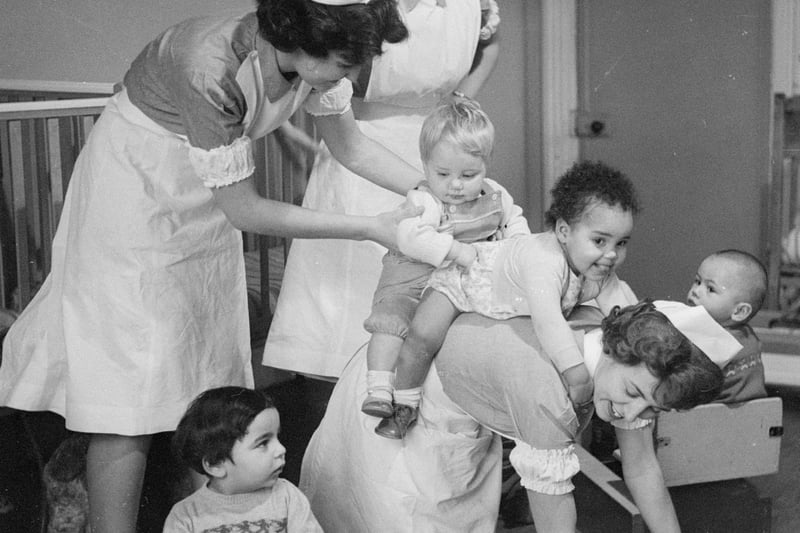 Student nurses play ‘piggy-back’ with the toddlers at Princess Christian College for Nursery Nurses in Manchester.  February 1962:  
