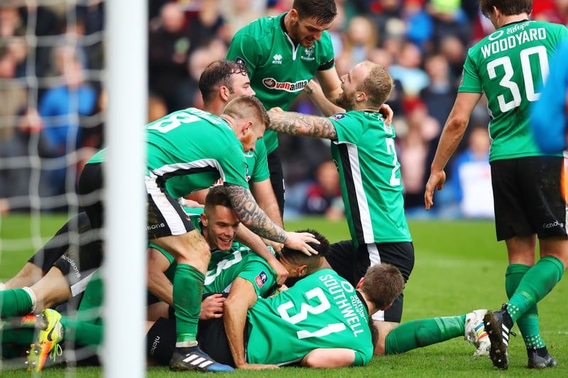 Lincoln became the first non-league side in 103 years to reach the FA Cup quarter-finals when Sean Raggett scored a dramatic late winner against Burnley at Turf Moor.