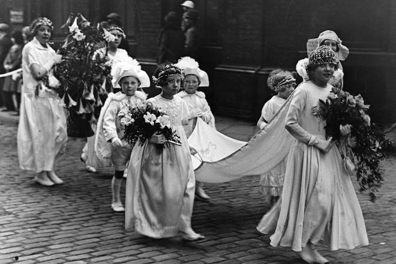 Closer to home, a  group of girls from Manchester and Salford participate in a Whit Monday march circa 1935