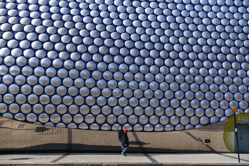 A man walks past the Bull Ring shopping centre on March 24, 2020 