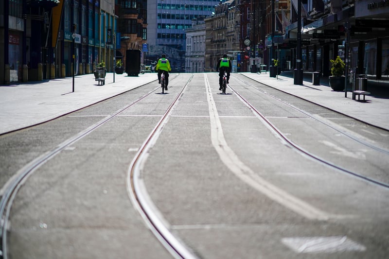 Police officers patrol a deserted Corporation Street in Birmingham city centre on March 29, 2020