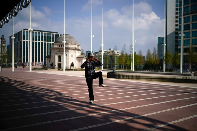A woman practises Tai chi in Centenary Square during the pandemic lockdown on May 4, 2020 in Birmingham