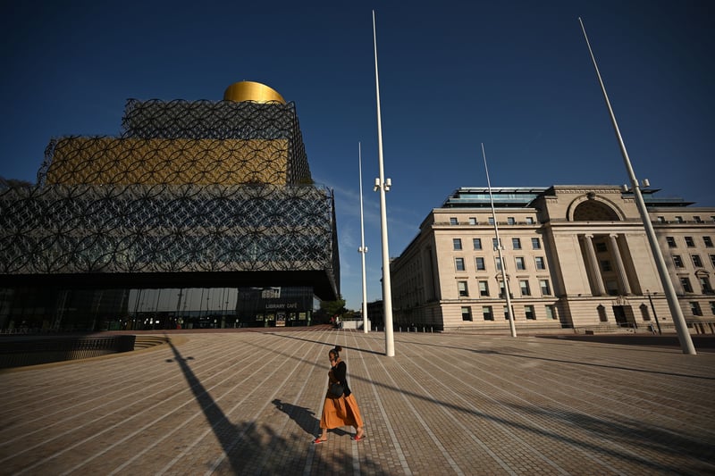 A woman walks through Birmingham city centre on September 14, 2020 after the government imposed fresh restrictions on the city after a rise in cases of Covid-19