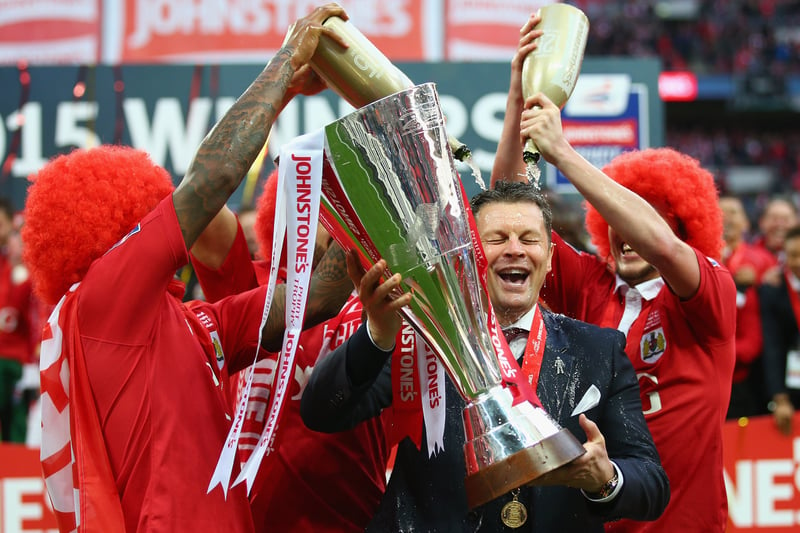 The champagne is poured over winning gaffer Steve Cotterill.