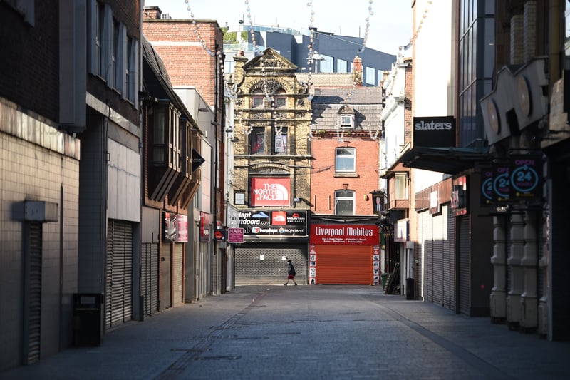 A person walks in a quiet street in the centre of Liverpool.
