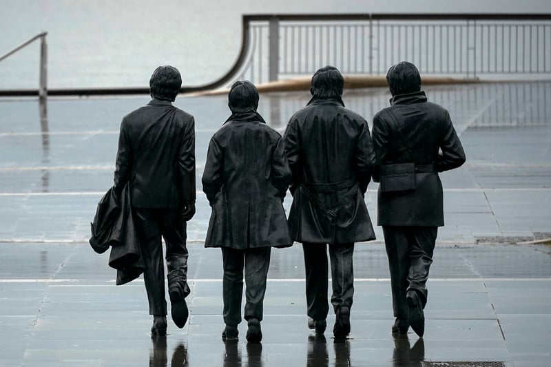 The Beatles statues stand alone on a deserted Pier Head.