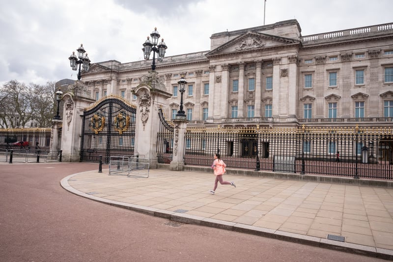 A jogger runs along the deserted pavements around Buckingham Palace, normally full of throngs of tourists. Photo by Leon Neal/Getty Images