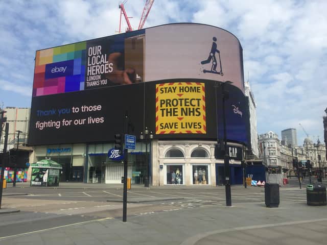 The slogan of “stay home, protect the NHS, save lives” is projected across an empty Piccadilly Circus during the first lockdown.