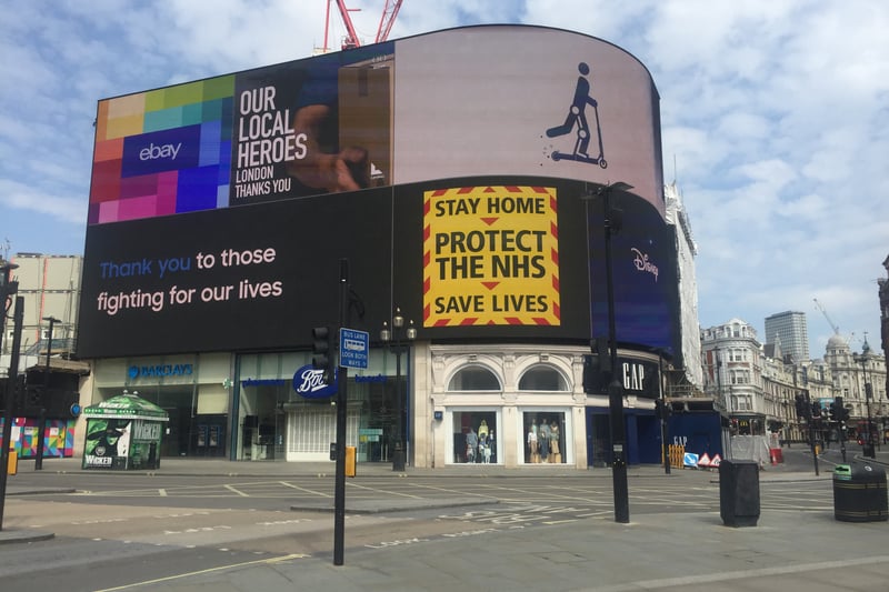 The slogan of “stay home, protect the NHS, save lives” is projected across an empty Piccadilly Circus during the first lockdown.