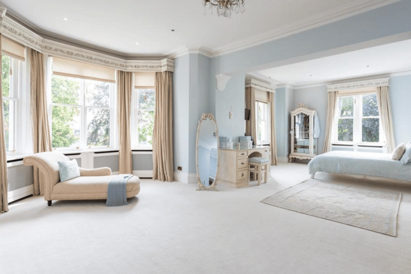Gorgeous bay windows allow lots of light in the master bedroom