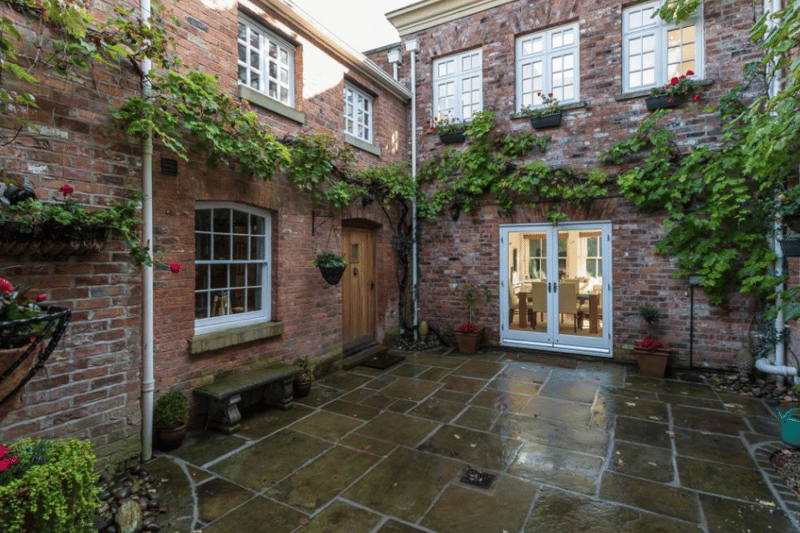 A lovely paved courtyard leads out onto the gardens