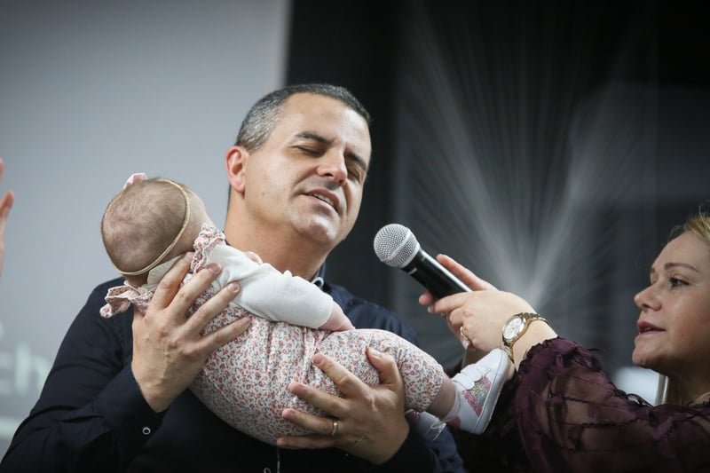 A baby being dedicated. Photo: Phil Taylor
